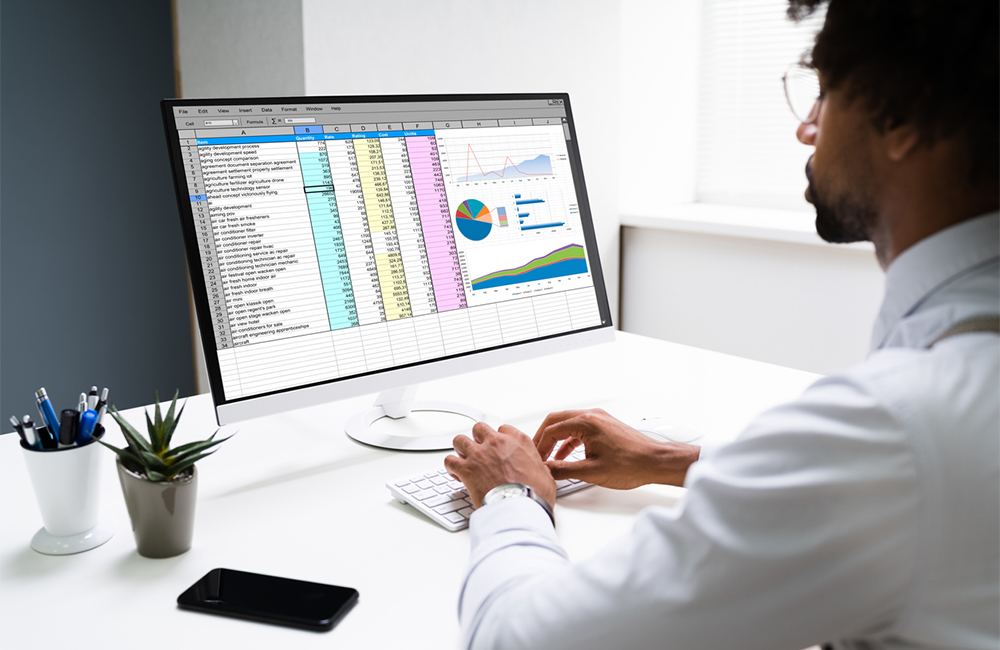 man types on keyboard to edit Excel chart