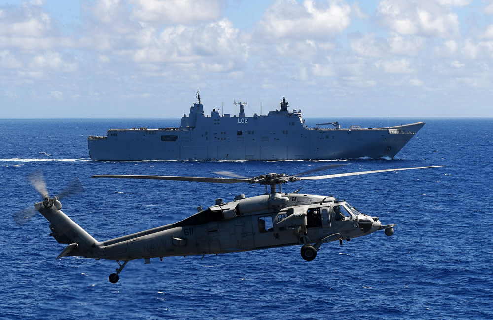 image of PACIFIC OCEAN (June 23, 2022) An MH-60S Sea Hawk helicopter, assigned to the “Chargers” of Helicopter Sea Combat Squadron (HSC) 14, hovers above the flight deck of Nimit