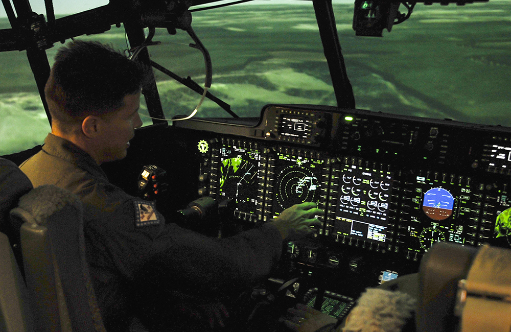 image of Lt. Col. James Gourde, a 154th Training Squadron C-130H pilot, flies a C-130H flight simulator April 6, 2015, at Little Rock Air Force Base, Ark.