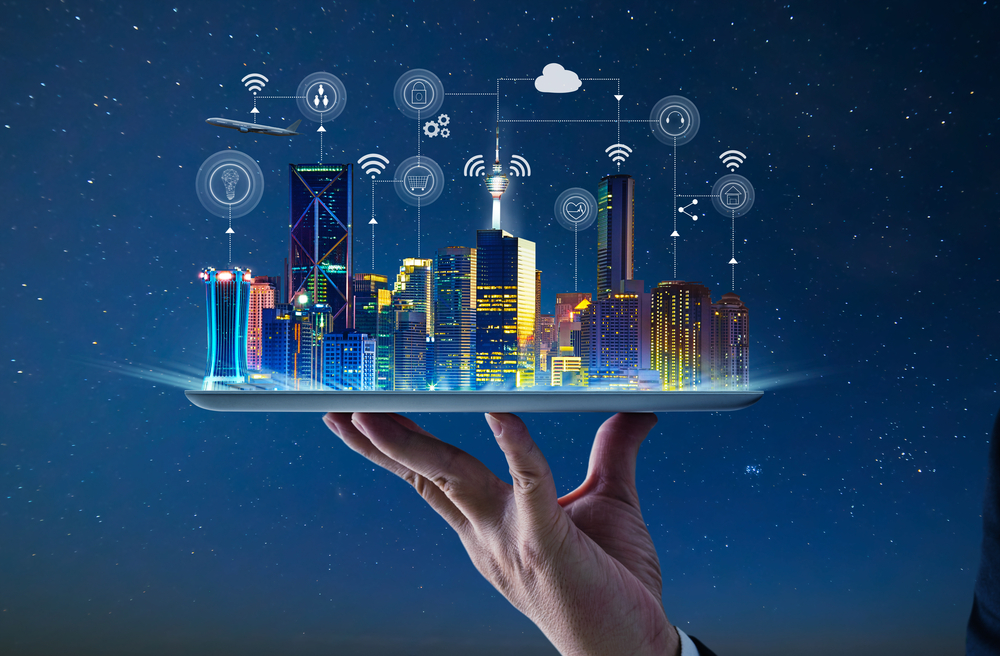Waiter hand holding an empty digital tablet with Smart city with smart services and icons, internet of things, networks and augmented reality concept , night scene