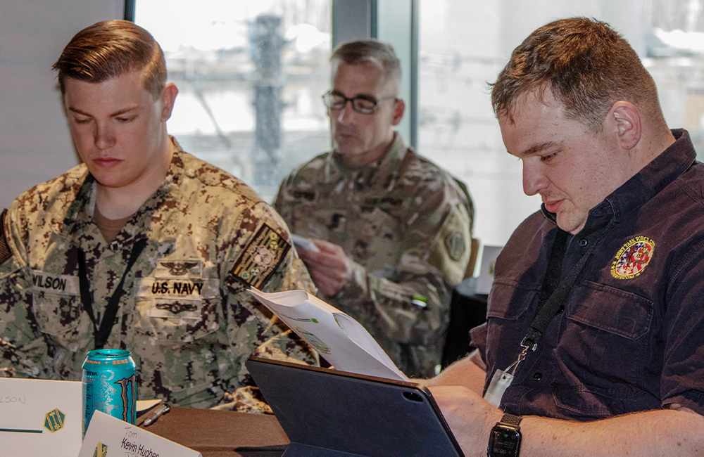 image of U.S. Navy teams with a civilian emergency response partner to tackle a cyber-attack scenario during exercise Cyber Impact 22 in Buffalo, New York, Mar. 9, 2022.