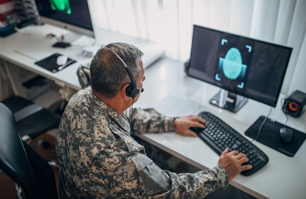 Army soldier using computer for identification blue digital fingerprint