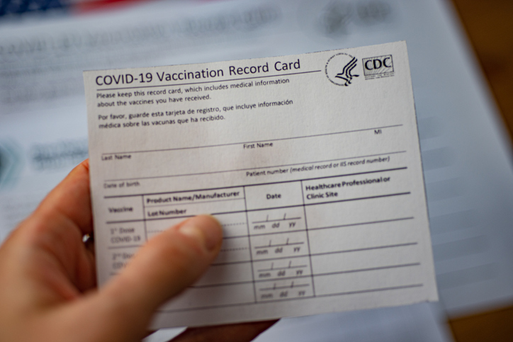 Washington, Dc, USA - December, 23,2020: Close up view of blurred COVID-19 Vaccination Record Card by CDC in hand.