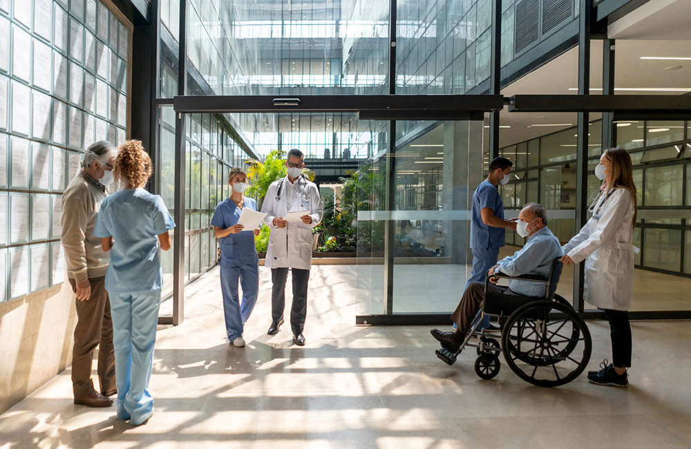 People walking in and out of the hospital - Healthcare concepts