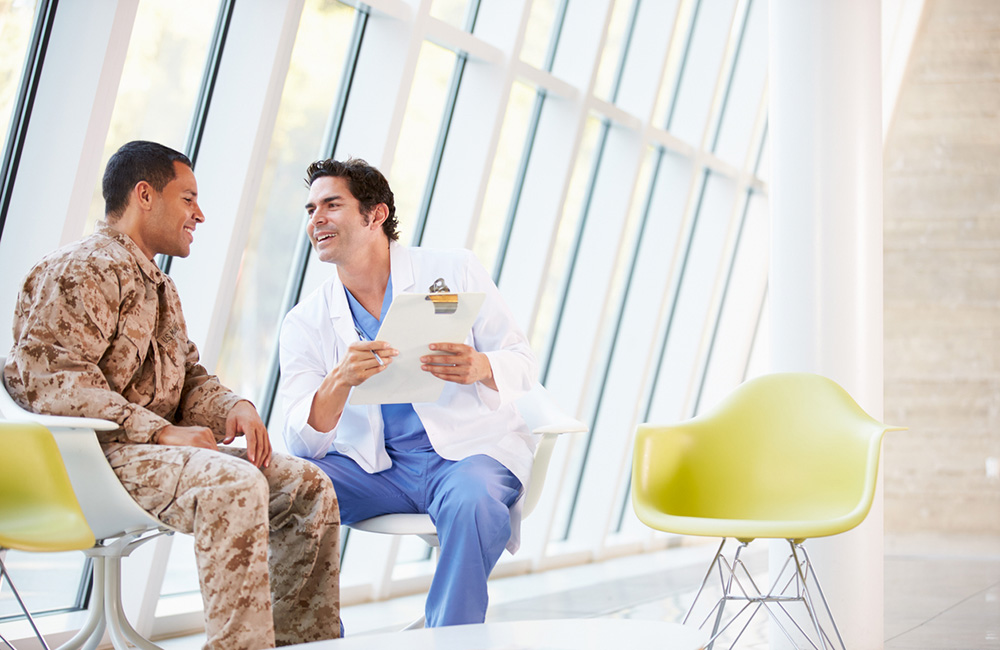 Doctor Counselling Soldier Suffering From Stress Having A Discussion