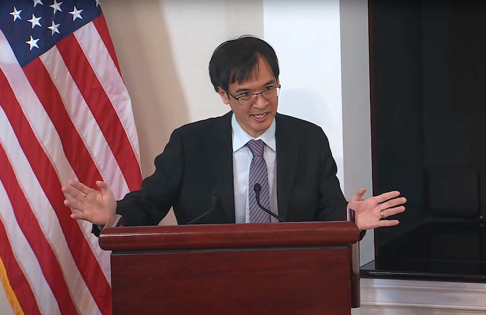 Terence Tao speaks at a podium in the White House.