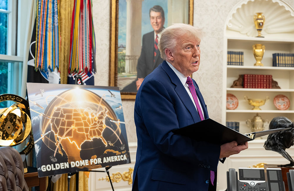 Donald Trump speaks with officials and staff in the Oval Office during the announcement of the Golden Dome missile defense system on May 20, 2025.