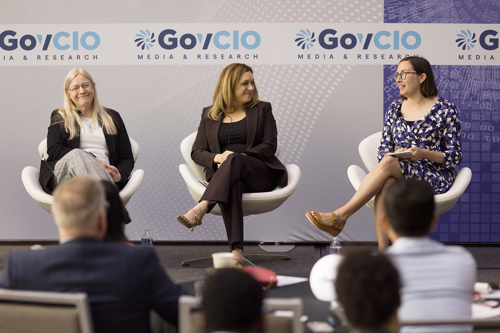 A group of presenters speak at the Federal Tech Leaders Summit
