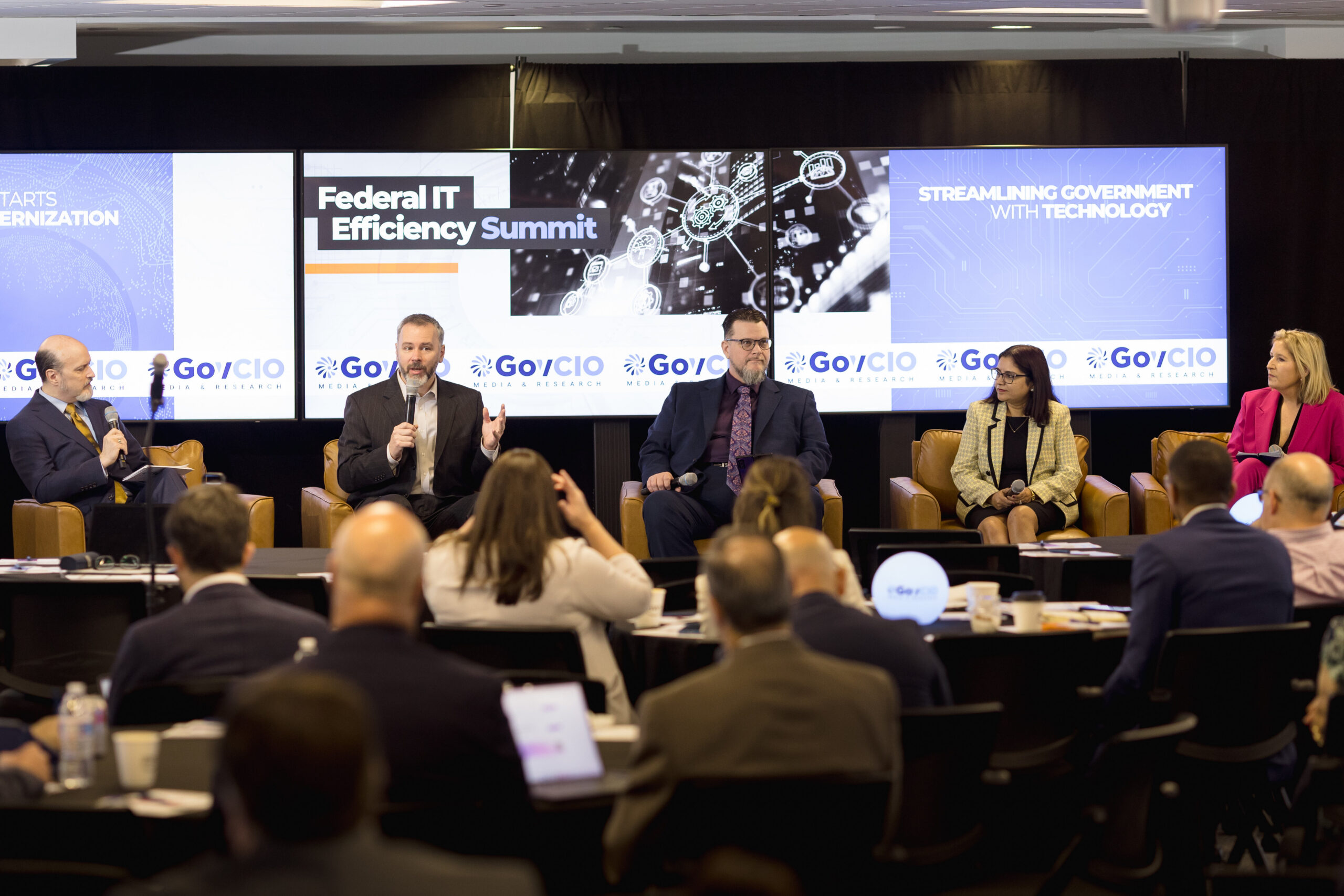 Photo of speakers at the 2026 Federal IT Efficiency Summit in Reston, VA