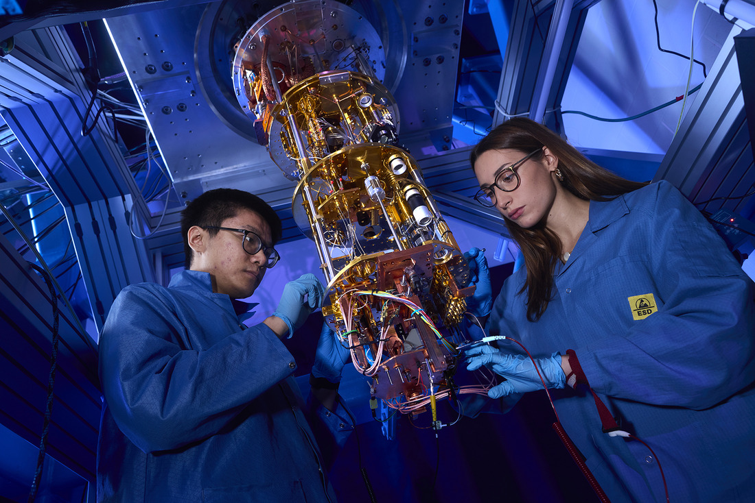 Two UConn researchers work on a quantum computer as a part of the UConn Quantum Alliance.