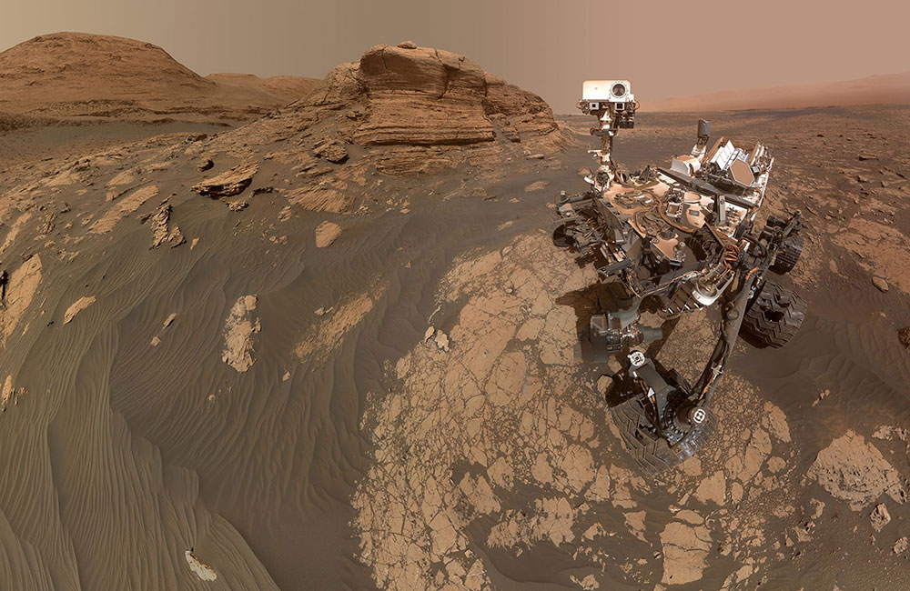NASA’s Curiosity Mars rover used two cameras to create this selfie in front of Mont Mercou, a rock outcrop that stands 20 feet tall.