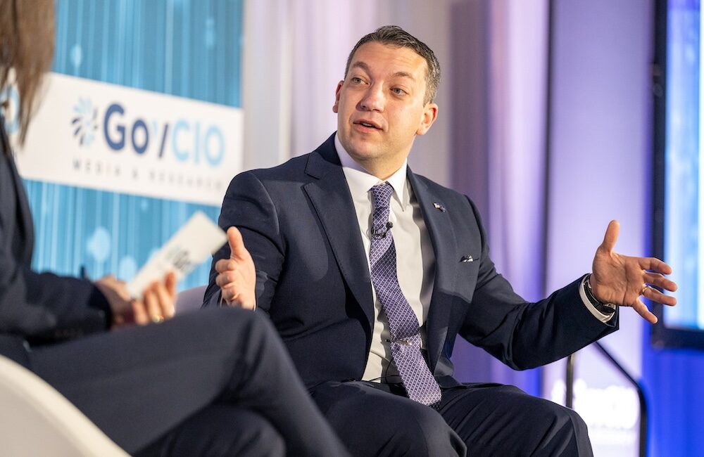 Jake Glassman, deputy assistant secretary of war for Science and Technology Foundations, speaks at GovCIO Media & Research's AI Summit in Tysons, Virginia, on Jan. 9, 2025.
