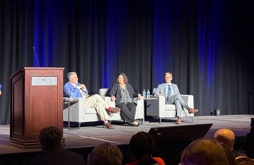 Ryan Howells, principal at Leavitt Partners; Amy Gleason, acting administrator at U.S. DOGE Service and strategic advisor for CMS; Tom Keane, assistant secretary for technology policy, speak at the ASTP Annual Meeting on Feb. 12, 2026, in Washington, D.C.