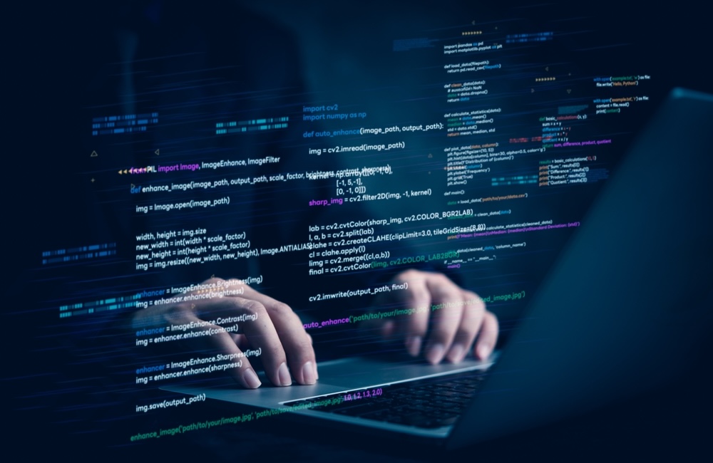 Hands typing on laptop with programming code on screen, representing software development. Perfect for coding, IT solutions, digital technology, web applications.