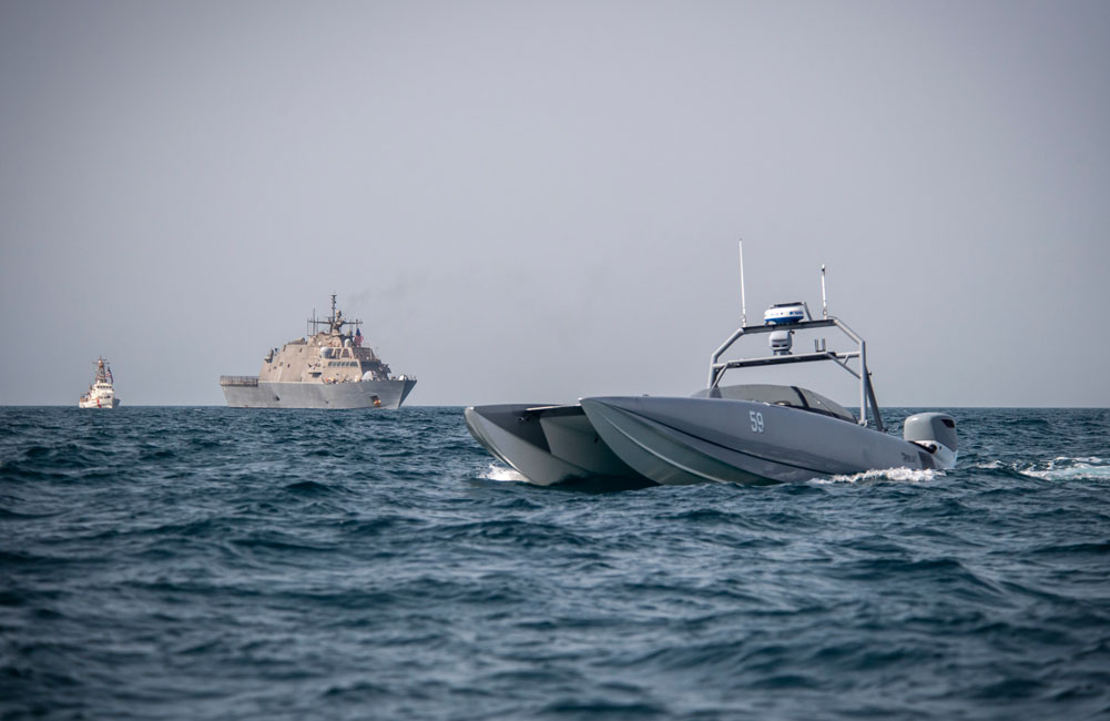 A Devil Ray T-38 unmanned surface vessel, littoral combat ship USS Sioux City (LCS 11 and U.S. Coast Guard cutter USCGC Baranof (WPB 1318) sail in the Arabian Gulf in 2002.