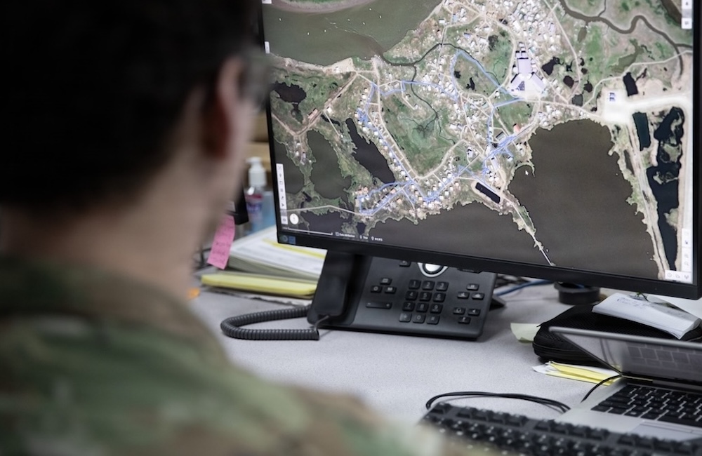 Tech. Sgt. Wolf Russo, common operating picture manager with the Alaska National Guard’s Joint Force Headquarters, demonstrates capabilities of Maven in response to Western Alaska storms at Joint Base-Elmendorf in Richardson, Alaska. Nov. 10, 2025.